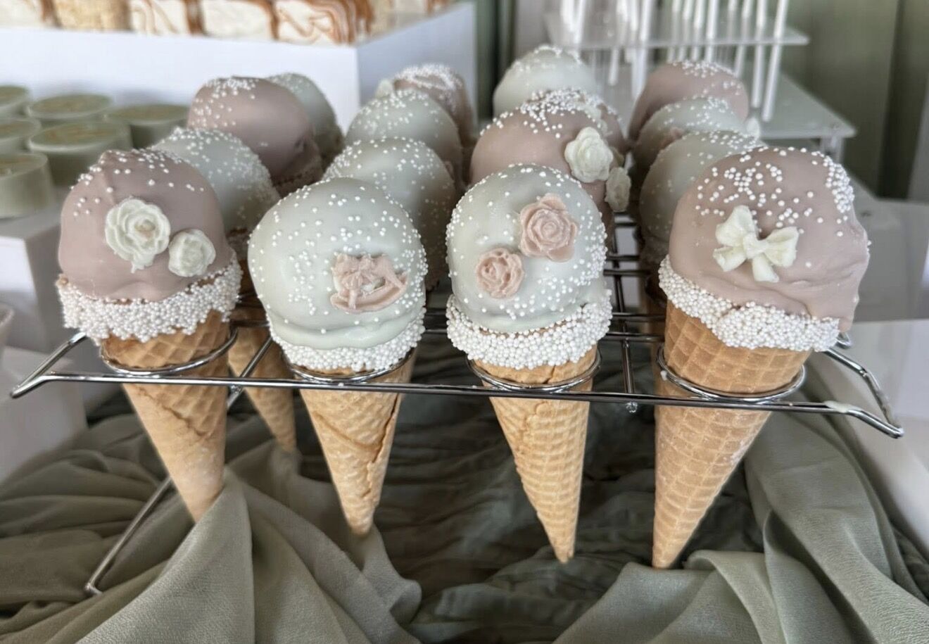 Blush cake pop cones with floral accents